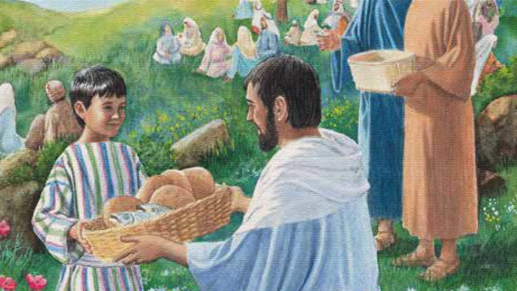Man serving bread to a child at an outdoor gathering with many people.