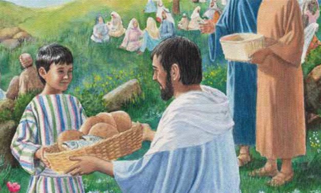 Man serving bread to a child at an outdoor gathering with many people.