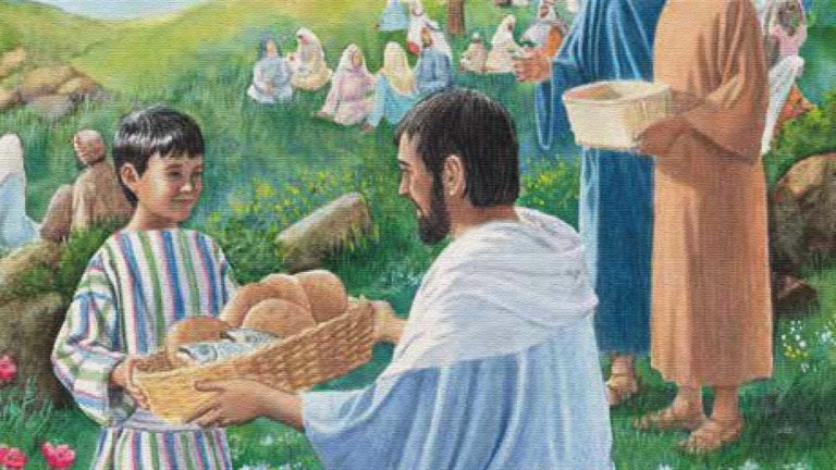 Man serving bread to a child at an outdoor gathering with many people.