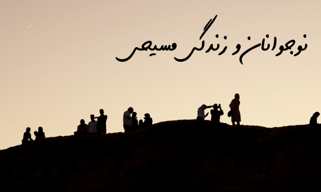 Silhouettes of people on a hill against a warm sunset sky.
