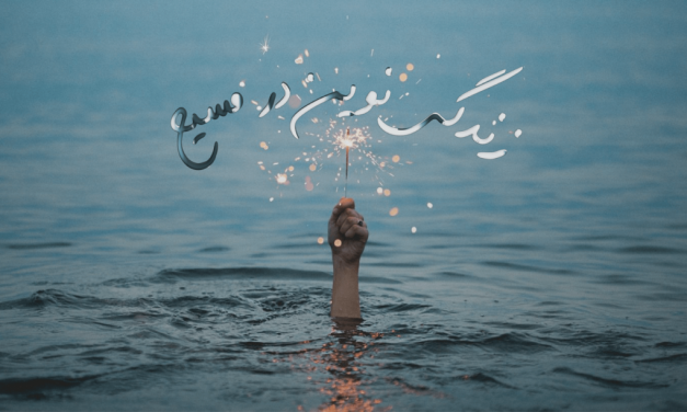 Hand rising from ocean holding lit sparkler